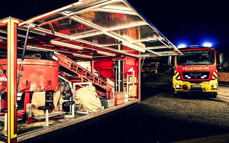 Abrollbehälter Sandsack